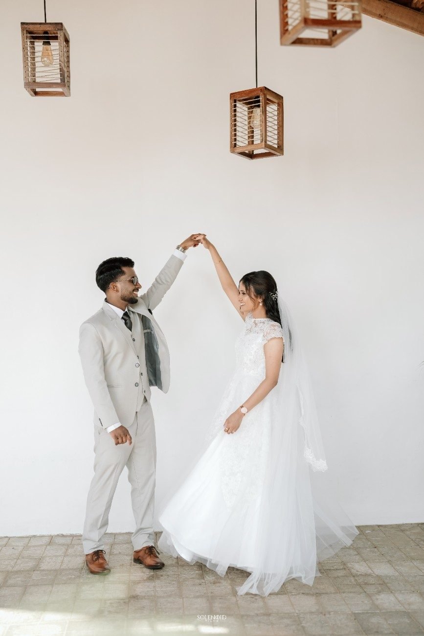 Christian couple twirling during their wedding celebration