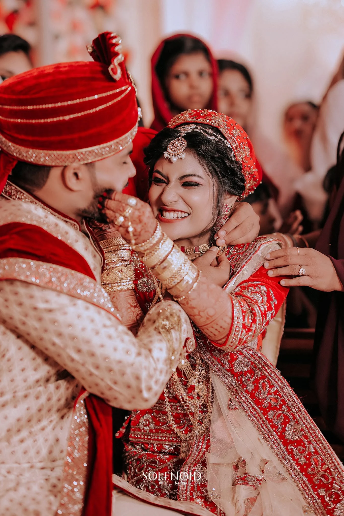 A natural candid moment between a Kerala bride and groom
